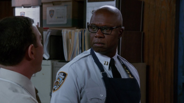 Holt wearing an apron and looking at Boyle on Brooklyn Nine-Nine S2E9