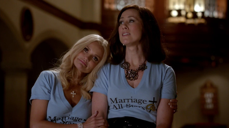 Carlene Cockburn (Kristin Chenoweth) hugging Cricket (Miriam Shor) in GCB