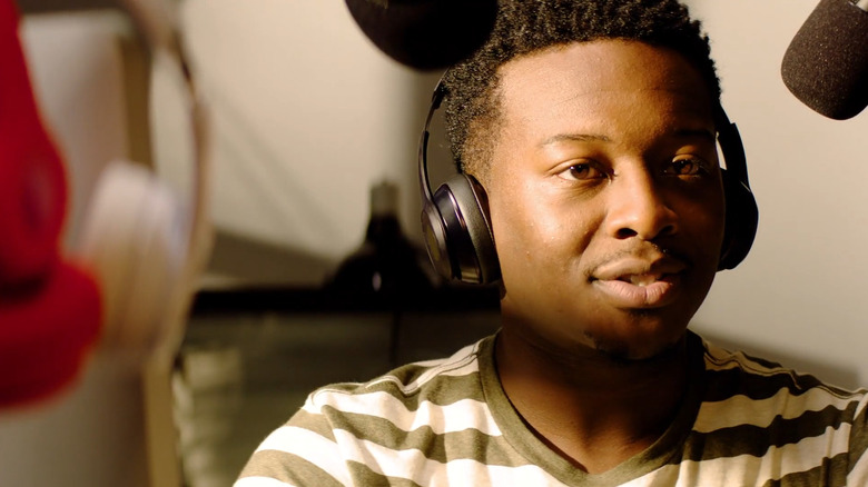 Miles Finer (Brandon Micheal Hall) speaking into a microphone in God Friended Me