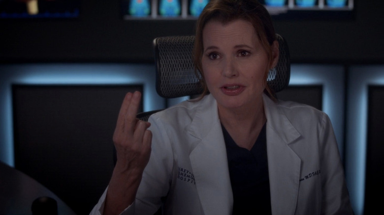 Dr. Nicole Herman in white doctor's coat holding up two fingers while speaking