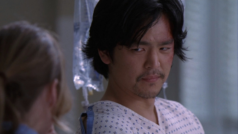 Marshall Stone in hospital gown, looking at Meredith (face not visible)