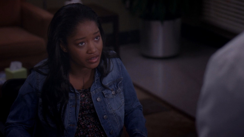 Sheryll Jeffries wearing jean jacket and looking up while talking
