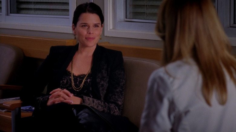 Dr. Lizzie Shepherd sitting in front of Meredith (face not visible), and smiling