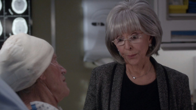 Gayle McColl standing by hospital bed in conversation