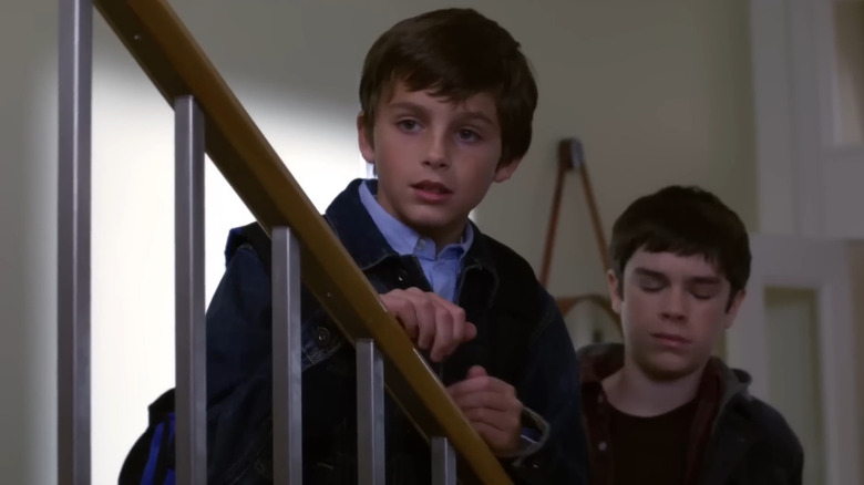 Timothée Chalamet as Eric Foley, standing on the stairs in Law & Order.