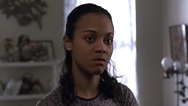 Zoe Saldaña as Belinca, scowling in her room in Law & Order.