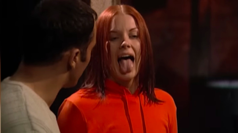 Woman with read hair sticking out her tongue on Fear Factor