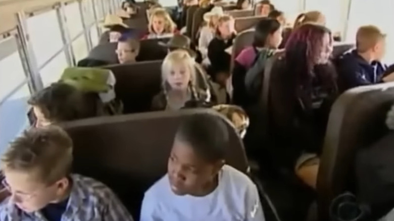 Kids sitting on bus in Kid Nation
