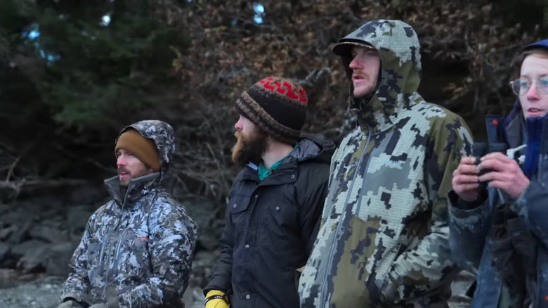 Contestants on Outlast standing in heavy jackets