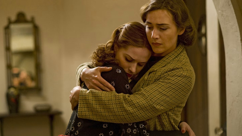 Kate Winslet as Mildred Pierce and Evan Rachel Wood as Veda Pierce, embracing in Mildred Pierce.