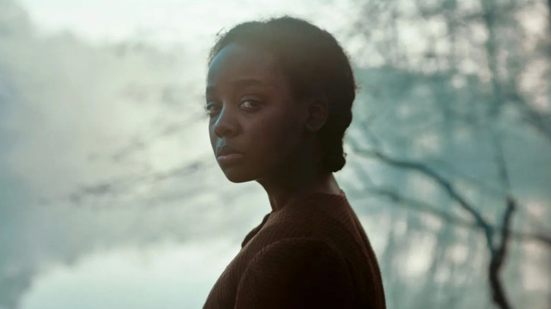 Thuso Mbedu as Cora Randall, looking over her shoulder in The Underground Railroad.