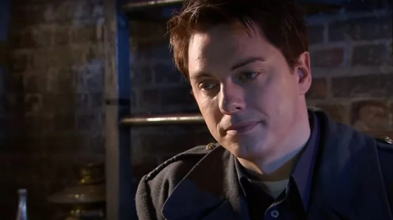 John Barrowman's Captain Jack Harkness looking thoughtful on Torchwood