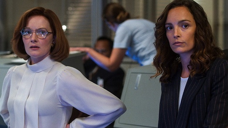 Wrenn Schmidt as Margo Madison standing next to Jodi Balfour as Ellen Waverly in NASA control room in For All Mankind