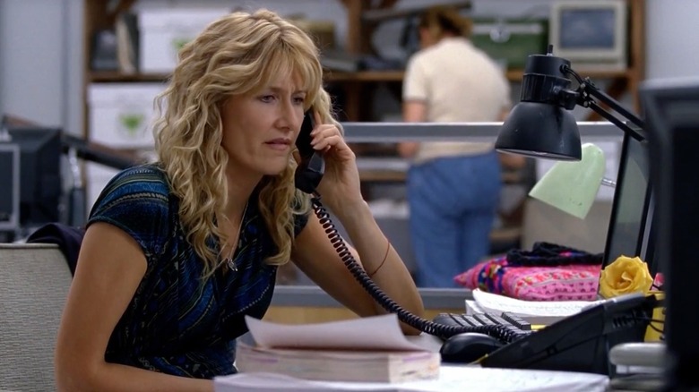 Amy seated at office desk and on the phone