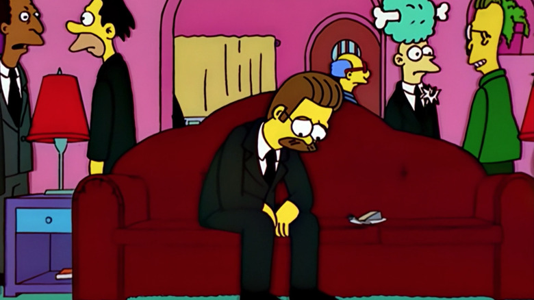 Ned Flanders sits on the couch sadly in "Alone Again, Natura-Diddly"