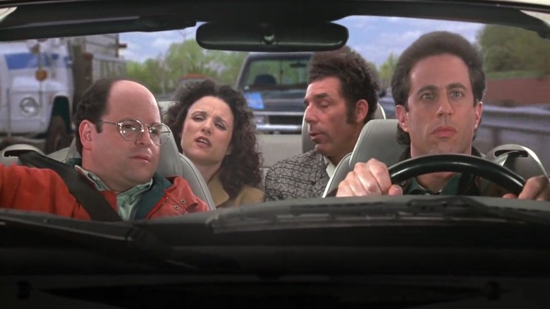 Jason Alexander, Julia Louis-Dreyfus, Michael Richards, and Jerry Seinfeld as George, Elaine, Kramer, and Jerry riding in a car in Seinfeld