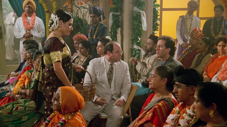 Elaine Benes (Julia Louis-Dreyfus), George Costanza (Jason Alexander), and Jerry Seinfeld attend a traditional Indian wedding on Seinfeld