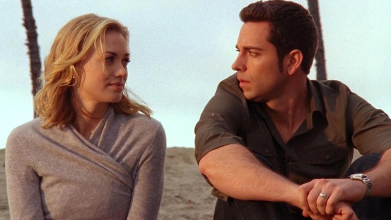 Yvonne Strahovski and Zachary Levi as Sarah and Chuck sitting together on a beach in Chuck