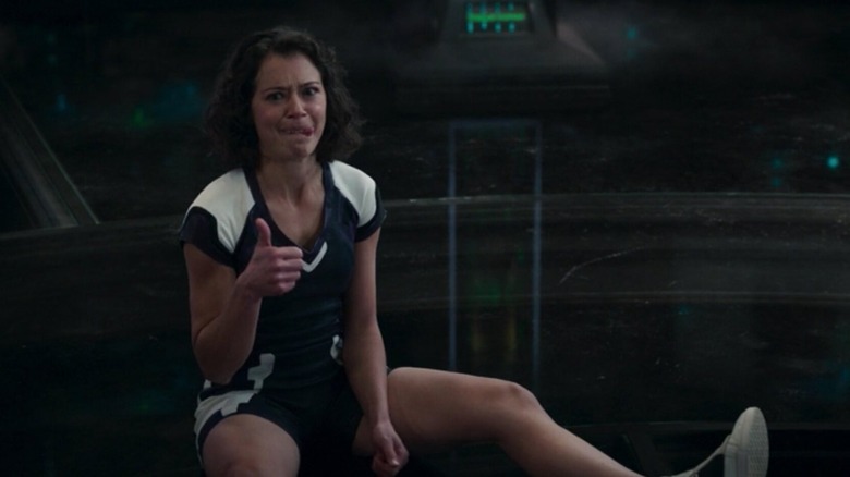 Tatiana Maslany as Jen Walters sitting with her tongue sticking out and giving a thumbs up in She-Hulk Attorney at Law