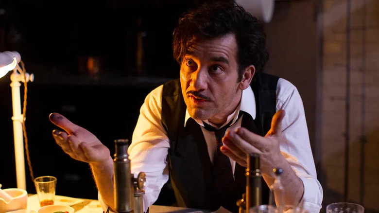John Thackery (Clive Owen) gestures over a table of medical equipment in The Knick