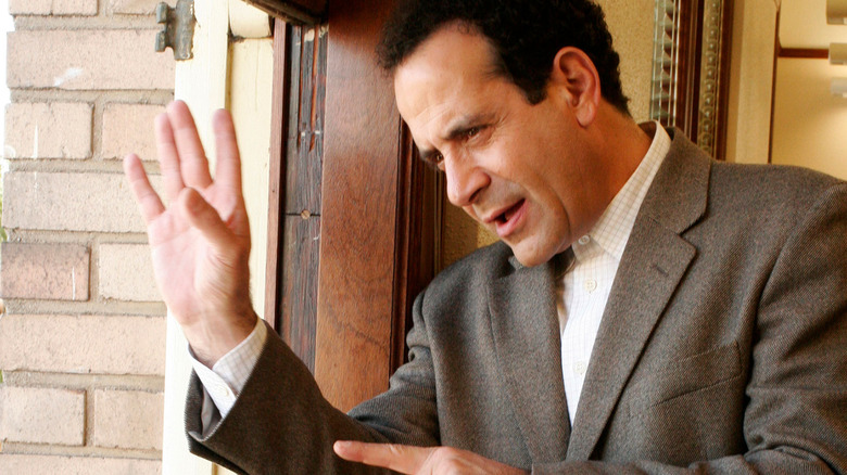 Tony Shalhoub as Adrian Monk looks out a window in Monk