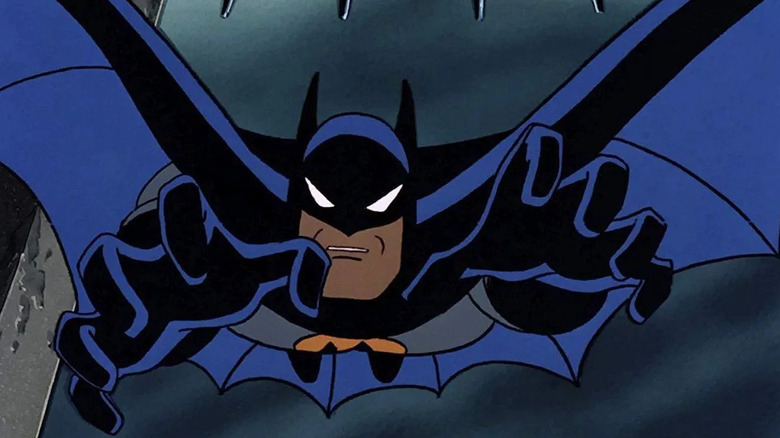 Batman leaps at a criminal in Batman: The Animated Series