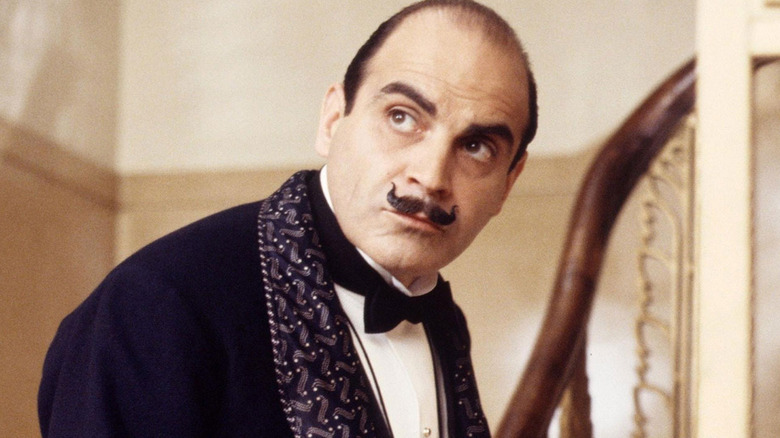 David Suchet as Hercule Poirot walks up some stairs in Agatha Christie's Poirot