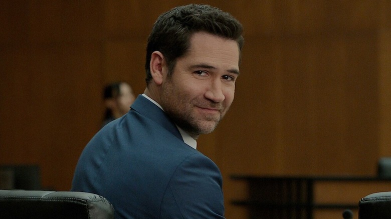Manuel Garcia-Rulfo as Mickey Haller, smiling over his shoulder in The Lincoln Lawyer.