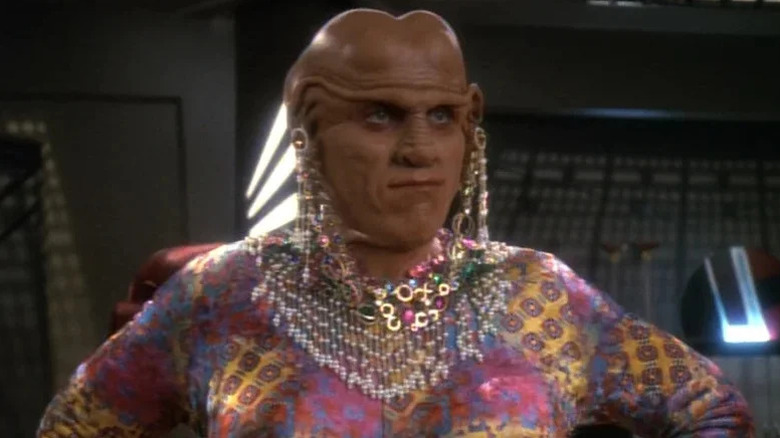 Quark (Armin Shimerman) stands transformed as a woman in Star Trek: Deep Space Nine