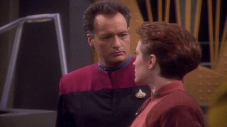 Q (John de Lancie) glances at Kira Nerys (Nana Visitor) in Star Trek: Deep Space Nine