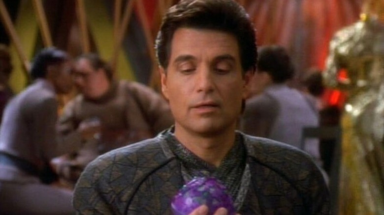 Martus Mazur (Chris Sarandon) studies his probability-altering device in Star Trek: Deep Space Nine
