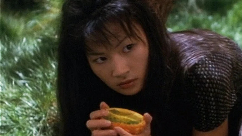 An older Molly O'Brien (Michelle Krusiec) looks up from eating a fruit in Star Trek: Deep Space Nine