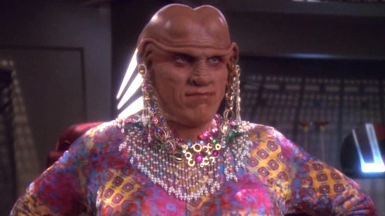 Quark (Armin Shimerman) stands disguised as a woman on Star Trek: Deep Space Nine