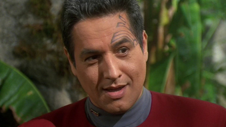Chakotay (Robert Beltran) stands excitedly in a jungle on Star Trek: Voyager