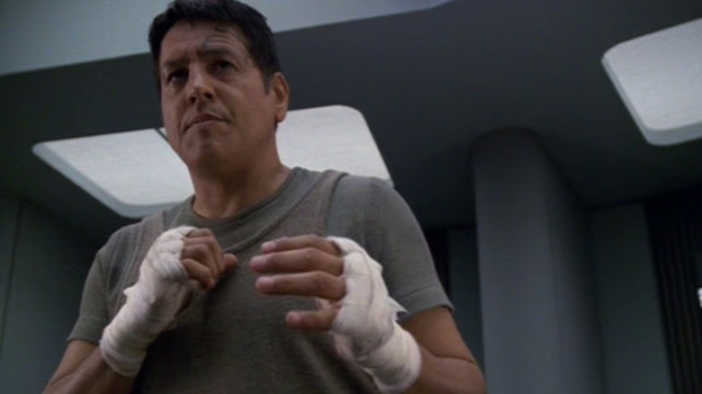 Chakotay (Robert Beltran) stands wearing hand wraps on Star Trek: Voyager