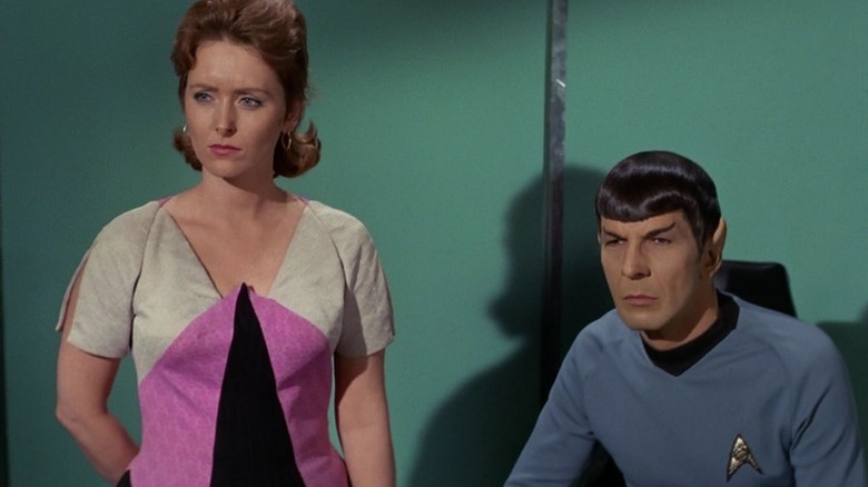 Janice Lester (Sandra Smith) stands next to seated Spock (Leonard Nimoy) on Star Trek: The Original Series