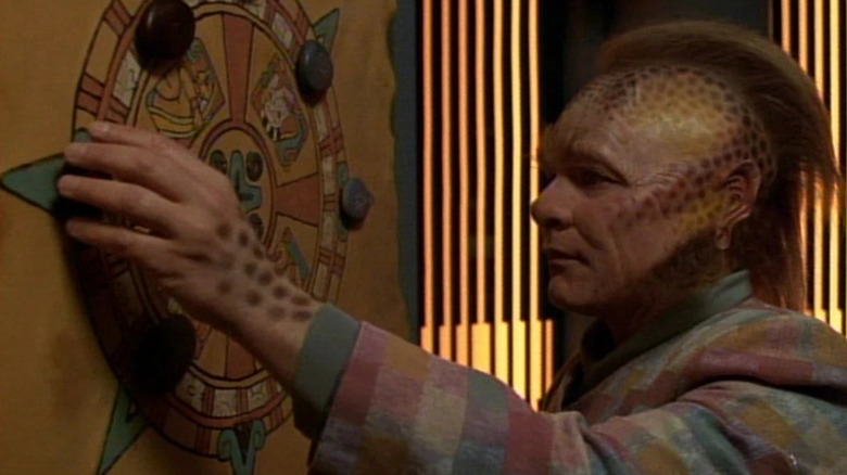 Neelix (Ethan Phillips) examines a healing wheel in Star Trek: Voyager