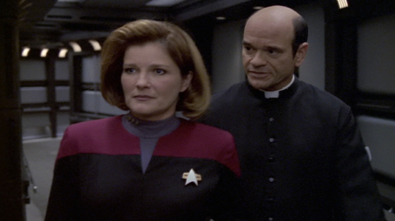 The Doctor (Robert Picardo) in priestly garbs speaks with Kathryn Janeway (Kate Mulgrew) in Star Trek: Voyager
