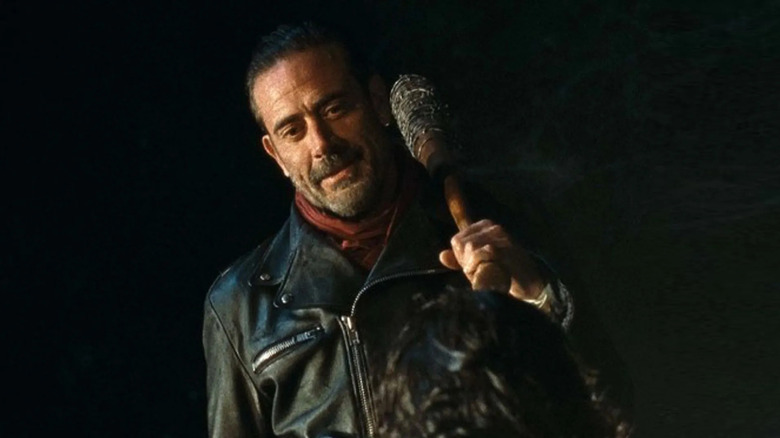 Jeffrey Dean Morgan as Negan, holding onto a bat and looking down in The Walking Dead.