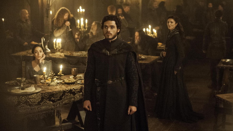 Richard Madden as Rob Stark, standing at his wedding in Game of Thrones.