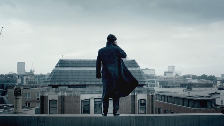 Benedict Cumberbatch as Sherlock Holmes, listening to a phone call looking out over London in Sherlock.