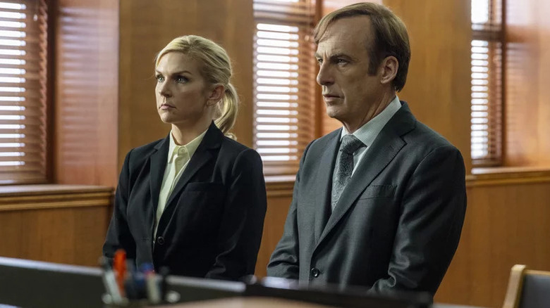 Rhea Seehorn's Kim Wexler and Bob Odenkirk's Jimmy McGill wearing business attire on Better Call Saul