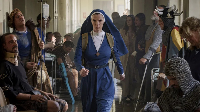 Betty Gilpin's Sister Simone wearing a nun's habit and marching through a hallway with injured people on Mrs. Davis