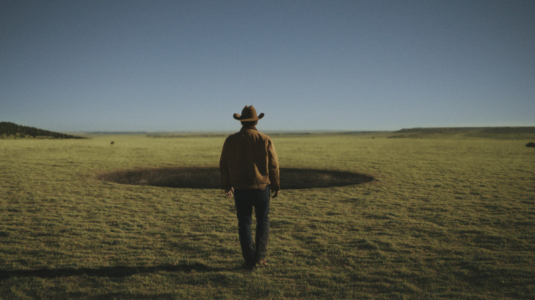 Josh Brolin's Royal Abbott walking toward a mysterious hole on Outer Range