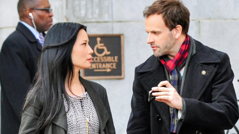 Lucy Liu as Dr. Joan Watson speaks with Johnny Lee Miller as Sherlock Holmes in Elementary