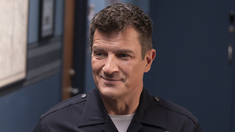 John Nolan (Nathan Fillion) smiles at work in The Rookie