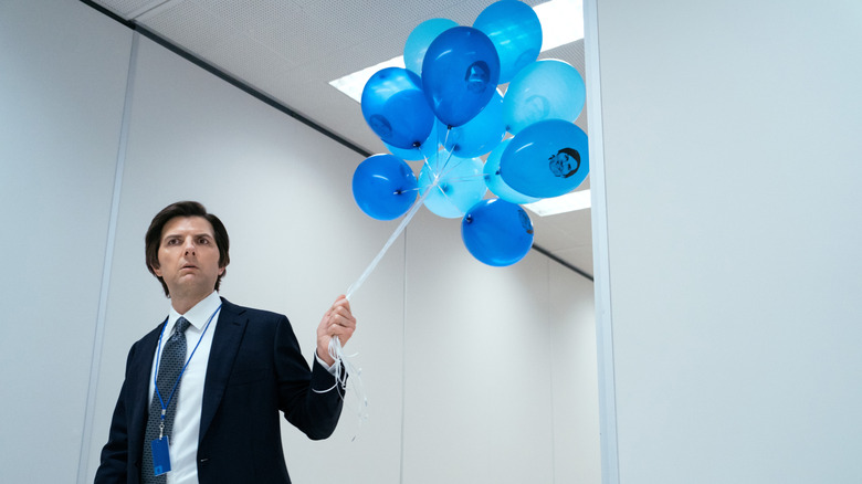 Mark in the hallway of the severed floor of Lumon holding balloons on Severance