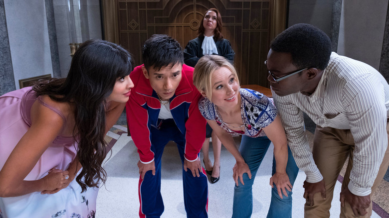 Tahani Jason Eleanor and Chidi plotting with the Judge behind them on The Good Place