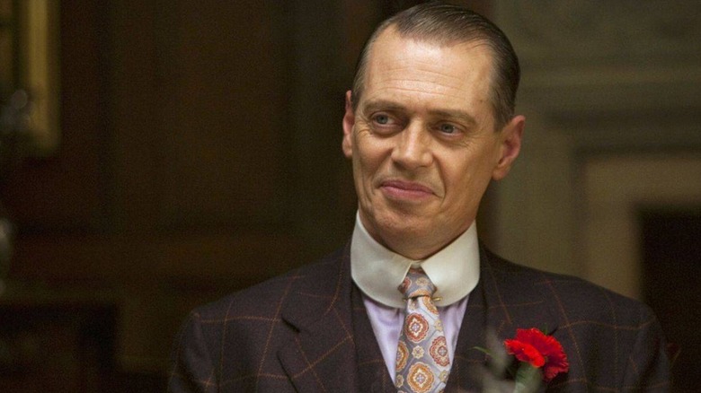 Nucky Thompson (Steve Buscemi) smiles warmly while wearing a suit in Boardwalk Empire