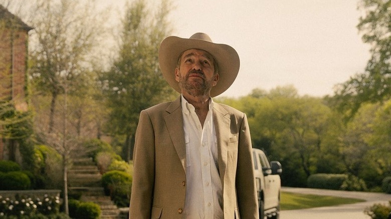 Tommy Norris (Billy Bob Thornton) stands in a driveway looking up in Landman